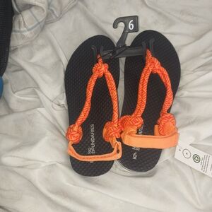 No Boundaries Black Sandals with Bright Orange Straps